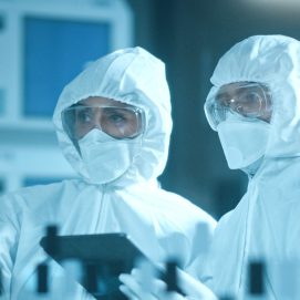 Two lab professionals in a cleanroom