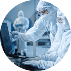 Professionals in a clean room working together at a computer