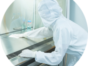 A lab professional cleans and disinfects surfaces